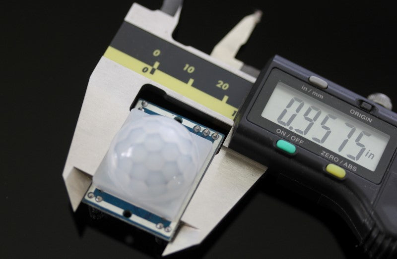 PIR Sensor with caliper. Measurement reads .9575 inches.