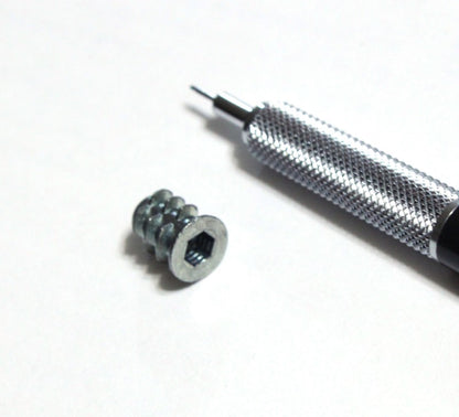 Number 8 insert nut shown with mechanical pencil for scale 