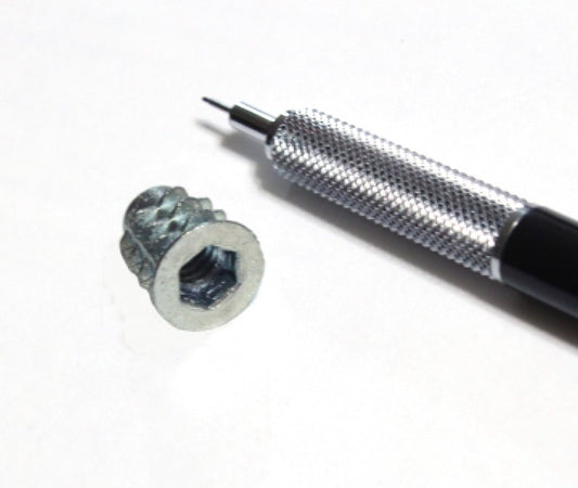 one quarter inch Insert Nut shown with mechanical pencil for scale 