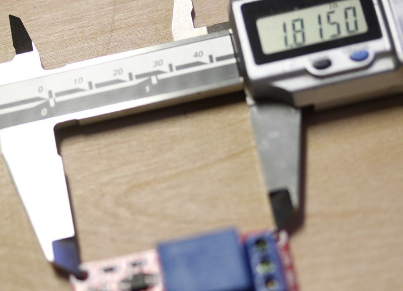 Dimension of the mounting holes that are farthest apart of the 24V dual relay module at 1.82 inches