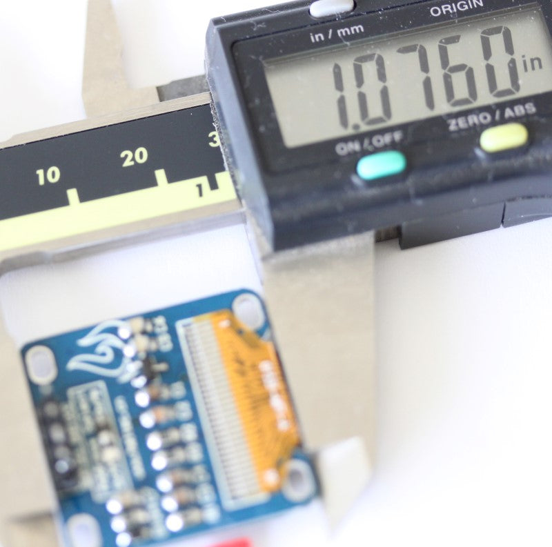 Height measurement of the 128x64 display module measuring 1.076 inches (27.3304 mm)