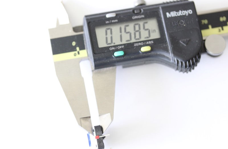 LED button shown with a caliper. The measurement reads .1585 inches. 