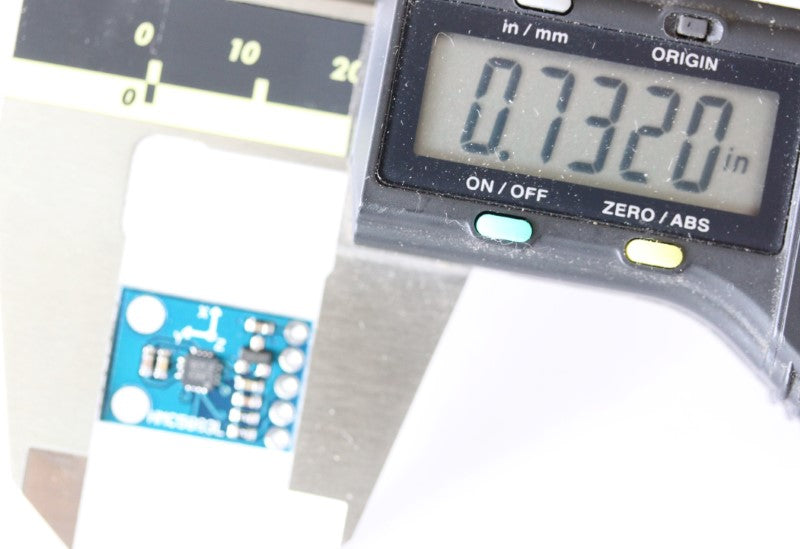 Triple Axis Magnetometer shown with caliper. The measurement reads .7320 inches (18.59 mm). 