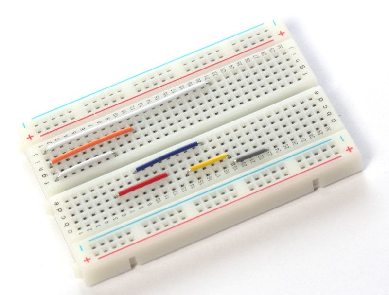 A Breadboard with different length jumper wires installed. 