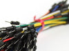 Thumbnail: A bundle of 65 jumper wires of various length and color. Bound together with the male connectors shown in the foreground. 