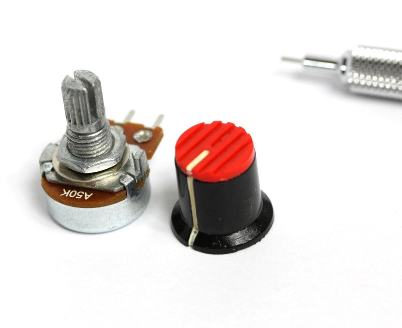 This image depicts a potentiometer and a small knob shown side by side with a pencil tip for scale. 